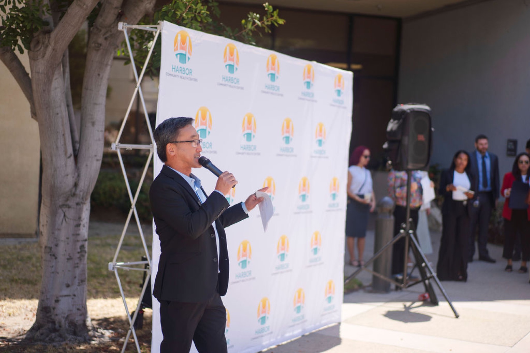 Stuart Takehara speaks to community members at the Harbor Community Health Centers grand opening in Long Beach