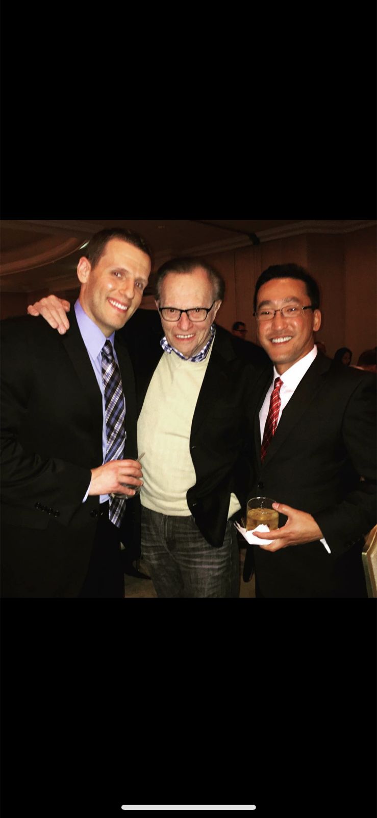Stuart Takehara and a colleague with broadcaster Larry King at an event